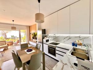 a kitchen with a table and a dining room at Olives Terrace B2A5 Apartment in Dhërmi
