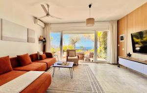 a living room with a couch and a table at Olives Terrace B2A5 Apartment in Dhërmi