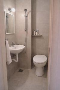 a bathroom with a toilet and a sink at Memories Studio in Neapoli Voion +5 photos