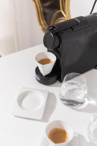 a camera and a cup of coffee on a table at Mare Suites 4 in Chania