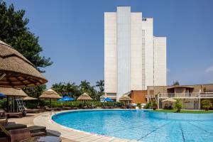 a swimming pool in front of a hotel at Constellation Apartments in Kampala
