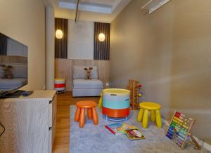 a childs room with a toy room with a table and stools at Seehotel Riviera at Lake Lucerne in Gersau +92 photos