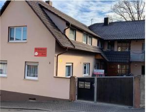 a white house with a gate and a fence at Haus Schwarzwald Marie in Mahlberg