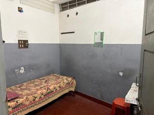 a small bedroom with a bed in a room at Star Hostel in Kannur