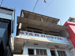 a star hospital sign on the side of a building at Star Hostel in Kannur