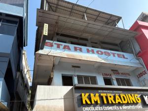 a star hospital sign on the side of a building at Star Hostel in Kannur