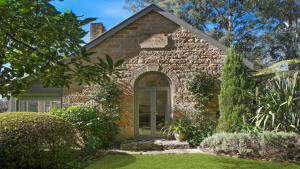 a brick house with a door in a yard at Protestant Hall in Wildes Meadow
