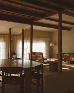 a living room with a wooden table and chairs at 蜜圡 Mitzdo in Tamano