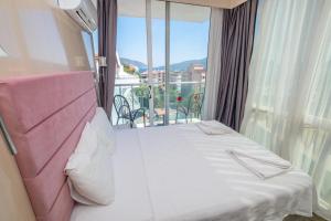 a hotel room with a bed and a balcony at Sunbay Park Hotel in Marmaris +31 photos