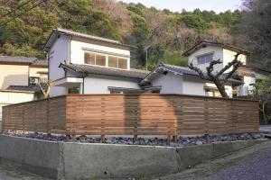 a wooden fence in front of a house at Beppu TOJIHAUS 001 2min walk to Shibaseki Onsen in Beppu