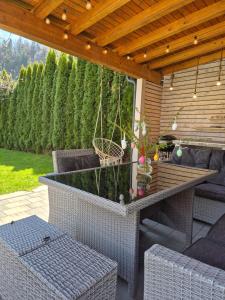 a patio with a table and chairs under a pergola at Green River Apartment in Stahovica +4 photos