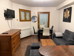 a living room with a couch and a table at Bartholomé LE MAGNIFIQUE in Drancy