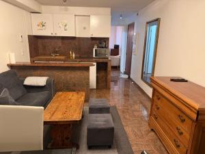 a living room with a couch and a table at Bartholomé LE MAGNIFIQUE in Drancy