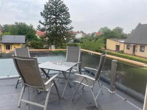 a table and chairs on a patio with a tree at Heinrich Heine in Tangermünde