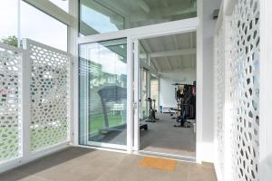 a gym with sliding glass doors and tread machines at Mary Pool - Giada in San Vito Chietino
