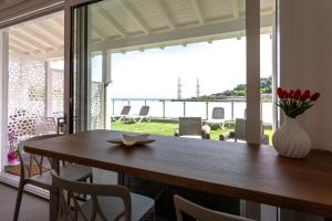 a dining room table with a vase of flowers on it at Mary Pool - Giada in San Vito Chietino