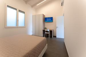a bedroom with a bed and a desk and a window at Mary Pool - Giada in San Vito Chietino +50 photos