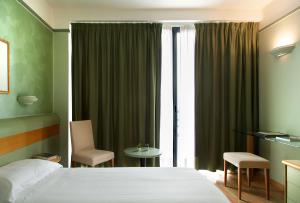 Posteľ alebo postele v izbe v ubytovaní Hotel Leonardo da Vinci
