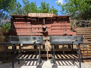 a large wooden structure with two benches in front of it at Fontana Oasis Apartment in Castelnuovo del Garda