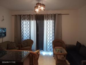 a living room with a couch and a table at Royal Chalet Sea View - Stella Di Mare - Families in Az Zafarani