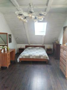 a bedroom with a bed and a dresser and a window at Guest House on Lesnaya in Leski