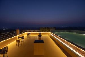 a pool on the roof of a building at night at Clarks Inn Suites Dhanbad in Dhanbād