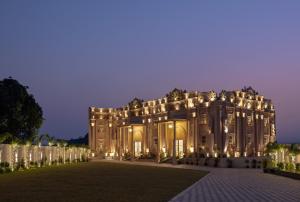 a large building with lights on it at night at Clarks Inn Suites Dhanbad in Dhanbād
