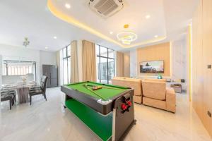a living room with a pool table in it at Silver Hill Pool Villa Pattaya in Na Jomtien