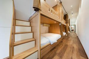a room with a bunk bed and a staircase at Nesta Home - Old Street in Hanoi