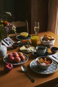 a table with plates of food and a glass of wine at Hotel St Petersinsel in Sankt Petersinsel +17 photos
