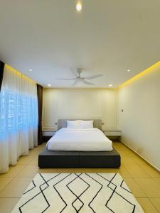 a bedroom with a white bed and a ceiling at Bayu Senja in Lahad Datu
