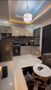 a kitchen with a couch and a table in a room at Luxury Homes in Lagos