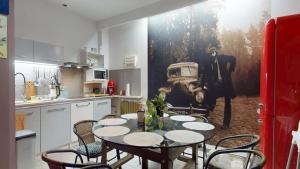 a kitchen with a table and chairs in a kitchen at Willa Mercedes in Gorzów Wielkopolski