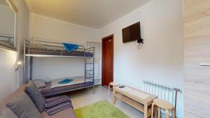 a living room with a couch and a bunk bed at Willa Mercedes in Gorzów Wielkopolski