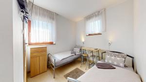 a bedroom with a bed and a desk and a chair at Willa Mercedes in Gorzów Wielkopolski