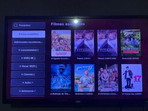 a television screen with a bunch of movies at Proximo ao Shopping e Aeroporto 2 Quartos com Ar e TV a Cabo in Várzea Grande