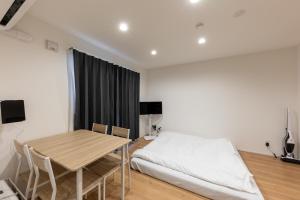 a bedroom with a table and a bed in it at HARUSAKU Omachi in Asahikawa