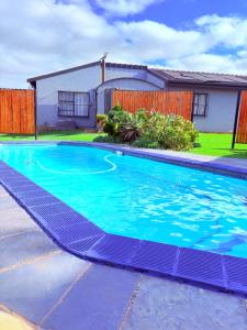 a swimming pool in a yard next to a house at 38 stay in eMalahleni