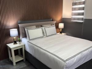 a bedroom with a large bed with two night stands at 38 stay in eMalahleni