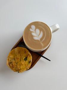a cup of coffee and a cookie on a tray at Seek First B&B in Pretoria
