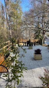 a park with benches and tables and trees at Villa Carla - Lago in Mezzolago