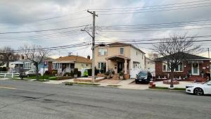 a house on the corner of a street with houses at Casseus J Legacy in Rosedale