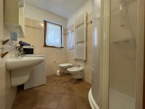 a bathroom with a sink and a toilet at Trilocale Carisolo 014 in Carisolo +34 photos