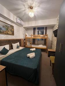 a hotel room with a bed with towels on it at Hotel Hirot in Tashkent