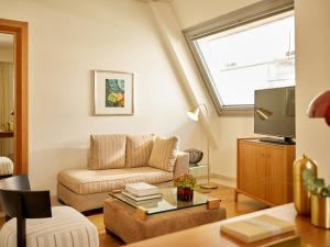 a living room with a couch and a tv at Daios Luxury Living in Thessaloniki