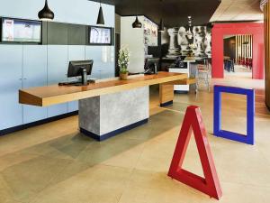 a lobby with a desk with a computer on it at ibis Rio Branco in Rio Branco