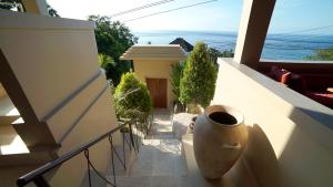 a balcony with a vase on the side of a building at Bayu - Ocean View - Boutique Hotel in Karangasem +34 photos