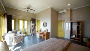 a bedroom with a bed and a living room at Bayu - Ocean View - Boutique Hotel in Karangasem