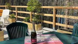 a bottle of wine sitting on a table with two glasses at Villa Carla - Bosco in Ledro +16 photos