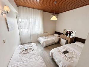 a bedroom with two beds and a window at Efendi Hotel old town special category in Istanbul +29 photos